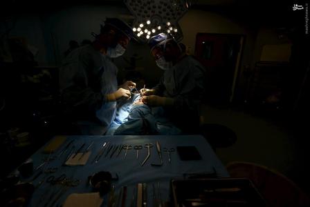 Iranian surgeon Ali Manafi performs a surgery on the nose a female patient in the operating room at a hospital in Tehran